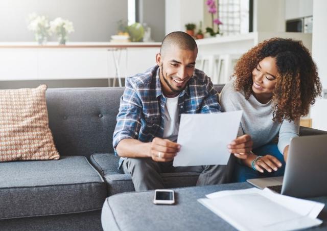 Couple looking at tax documents and smiling!